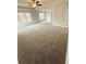 Spacious primary bedroom with plush carpet, ceiling fan, and multiple windows for natural light at 5518 Legacy Trl, Douglasville, GA 30135