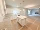 Bright kitchen features a center island, granite countertops, and white cabinets at 5518 Legacy Trl, Douglasville, GA 30135