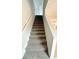 Carpeted staircase with white railing leading to the upper level of the home at 5518 Legacy Trl, Douglasville, GA 30135