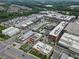 An aerial view showcasing a vibrant mixed-use community with commercial buildings and residential areas at 6460 Cortland Walk, Alpharetta, GA 30005