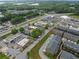 Aerial view of townhomes close to commercial area with shops, restaurants, and a gas station at 6460 Cortland Walk, Alpharetta, GA 30005