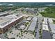 This aerial view presents the architecture of a modern mixed-use community, including businesses and residential blocks at 6460 Cortland Walk, Alpharetta, GA 30005