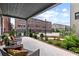 A covered back porch with a view of the community and comfortable seating at 6460 Cortland Walk, Alpharetta, GA 30005