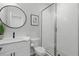 Bathroom featuring a glass-door shower, white cabinets and sink, and neutral walls at 6460 Cortland Walk, Alpharetta, GA 30005