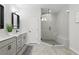 Modern bathroom featuring double sinks and a large glass-enclosed shower with a built-in seat at 6460 Cortland Walk, Alpharetta, GA 30005