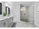 Modern bathroom featuring double vanities and a glass-enclosed shower at 6460 Cortland Walk, Alpharetta, GA 30005