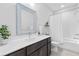 Bathroom features a white vanity, a shower with glass doors, and neutral paint at 6460 Cortland Walk, Alpharetta, GA 30005