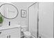 Bathroom features a vanity with a framed round mirror, a toilet, and a walk-in shower at 6460 Cortland Walk, Alpharetta, GA 30005