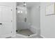 This bathroom features a spacious glass shower with tiled walls, a seat, and modern fixtures at 6460 Cortland Walk, Alpharetta, GA 30005