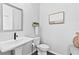 Elegant half-bathroom featuring a pedestal sink, classic fixtures, and clean design at 6460 Cortland Walk, Alpharetta, GA 30005