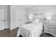 Bright bedroom with a bed, bedside tables, closet, and large window, offering a serene space at 6460 Cortland Walk, Alpharetta, GA 30005