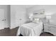 Bedroom features neutral paint, dark hardwood floors, and a double door closet at 6460 Cortland Walk, Alpharetta, GA 30005
