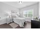 Bright bedroom with dark wood floors, light gray walls, and a large window at 6460 Cortland Walk, Alpharetta, GA 30005