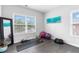 Bonus room features wood floors, a mirror, art work, and natural light from two windows at 6460 Cortland Walk, Alpharetta, GA 30005