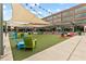 Relaxing community space featuring colorful Adirondack chairs, lawn games and shaded pergolas at 6460 Cortland Walk, Alpharetta, GA 30005