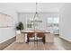 Bright dining room featuring a wooden table, stylish seating, and modern chandelier at 6460 Cortland Walk, Alpharetta, GA 30005