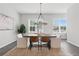 Bright dining room features a modern chandelier, large table, and natural light at 6460 Cortland Walk, Alpharetta, GA 30005