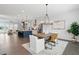 Open concept kitchen and dining features an island with bar stool seating and a modern dining set at 6460 Cortland Walk, Alpharetta, GA 30005