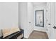 A clean entryway with gray walls, wood floors, and a mirrored decor item on the wall at 6460 Cortland Walk, Alpharetta, GA 30005