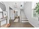 Bright foyer with a staircase, white walls, hardwood floors, and decorative accents at 6460 Cortland Walk, Alpharetta, GA 30005