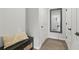 Hallway with hardwood flooring and a dark wood bench near a large mirror at 6460 Cortland Walk, Alpharetta, GA 30005