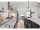 Gourmet kitchen features white and gray cabinets, quartz countertops, and designer fixtures at 6460 Cortland Walk, Alpharetta, GA 30005