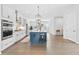 Spacious kitchen with white cabinets, stainless steel appliances, large island, and hardwood floors at 6460 Cortland Walk, Alpharetta, GA 30005
