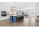 Bright, open kitchen with a large island, modern light fixtures, and stainless steel appliances at 6460 Cortland Walk, Alpharetta, GA 30005