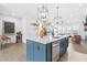 Open-concept kitchen with a blue island, stainless steel appliances, and hardwood floors at 6460 Cortland Walk, Alpharetta, GA 30005