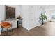 Wet bar area featuring a wine cooler, storage, hardwood floors, and an orange chair at 6460 Cortland Walk, Alpharetta, GA 30005
