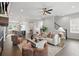 Open-concept living room with fireplace, stylish furniture, and seamless flow to the kitchen and staircase at 6460 Cortland Walk, Alpharetta, GA 30005