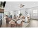 Cozy living room open to kitchen featuring plush seating and a modern fireplace at 6460 Cortland Walk, Alpharetta, GA 30005