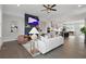 Inviting living room with fireplace, modern furnishings, and seamless transition to the kitchen and dining areas at 6460 Cortland Walk, Alpharetta, GA 30005
