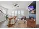 Cozy living room with fireplace, plush seating, and hardwood floors at 6460 Cortland Walk, Alpharetta, GA 30005