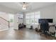 Cozy living room featuring wood floors, modern ceiling fan, and natural light at 6460 Cortland Walk, Alpharetta, GA 30005