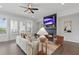 Bright living room with fireplace, modern furniture, and access to a charming outdoor space through French doors at 6460 Cortland Walk, Alpharetta, GA 30005
