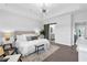 Bright main bedroom with modern sliding barn door leading to the bathroom at 6460 Cortland Walk, Alpharetta, GA 30005