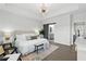 Bright main bedroom with a tray ceiling, pendant light, ensuite access, and hardwood floors at 6460 Cortland Walk, Alpharetta, GA 30005