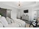Well-lit main bedroom featuring a tray ceiling, modern decor, and a barn door leading to the bathroom at 6460 Cortland Walk, Alpharetta, GA 30005