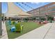 Halcyon's outdoor area with colorful seating, turf, and string lights for a vibrant and welcoming gathering space at 6460 Cortland Walk, Alpharetta, GA 30005