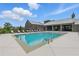 Resort-style community pool with lounge chairs, umbrellas, and covered seating area for relaxation at 6460 Cortland Walk, Alpharetta, GA 30005