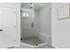 Contemporary glass-enclosed shower with a built-in bench seat at 6460 Cortland Walk, Alpharetta, GA 30005