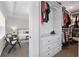 Walk-in closet with built in drawers connecting to the main bedroom at 6460 Cortland Walk, Alpharetta, GA 30005
