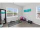 Bright workout room filled with workout equipment and hardwood flooring at 6460 Cortland Walk, Alpharetta, GA 30005