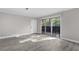 Living room with gray wood floors, sliding glass door to balcony, and neutral colored walls at 765 Houston Mill Ne Rd # 7, Atlanta, GA 30329
