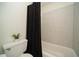 Cozy bathroom featuring a shower with decorative tile and a neutral-toned shower curtain for added privacy at 1207 Summit North Ne Dr # 1207, Atlanta, GA 30324