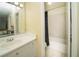 Bathroom featuring a vanity, a tub-shower with dark curtain and tile floors at 1207 Summit North Ne Dr # 1207, Atlanta, GA 30324