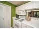This kitchen features white appliances and cabinets, and a serving window at 1207 Summit North Ne Dr # 1207, Atlanta, GA 30324