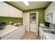Kitchen features white appliances and cabinets, as well as a washer and dryer behind folding doors at 1207 Summit North Ne Dr # 1207, Atlanta, GA 30324