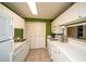 Efficient kitchen boasts white cabinets, modern appliances, and convenient access to the dining area at 1207 Summit North Ne Dr # 1207, Atlanta, GA 30324